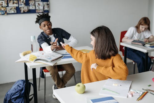 A GirlLending Eraser To Her Classmate