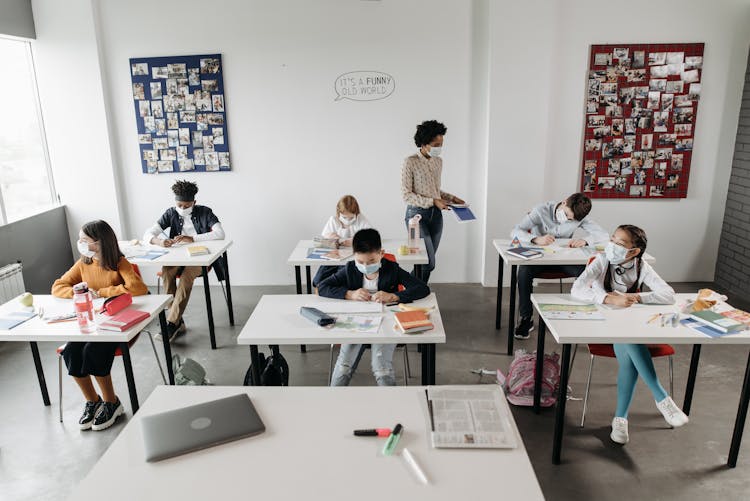 Students In A Classroom Wearing Face Masks During The New Normal State