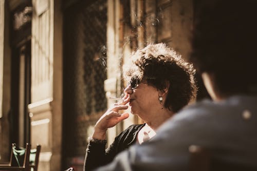Photography of a Woman Smoking Cigarette