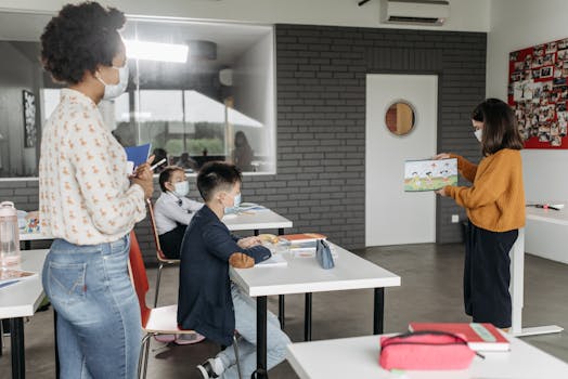 Students in a classroom wearing masks during a lesson, showcasing diverse education.