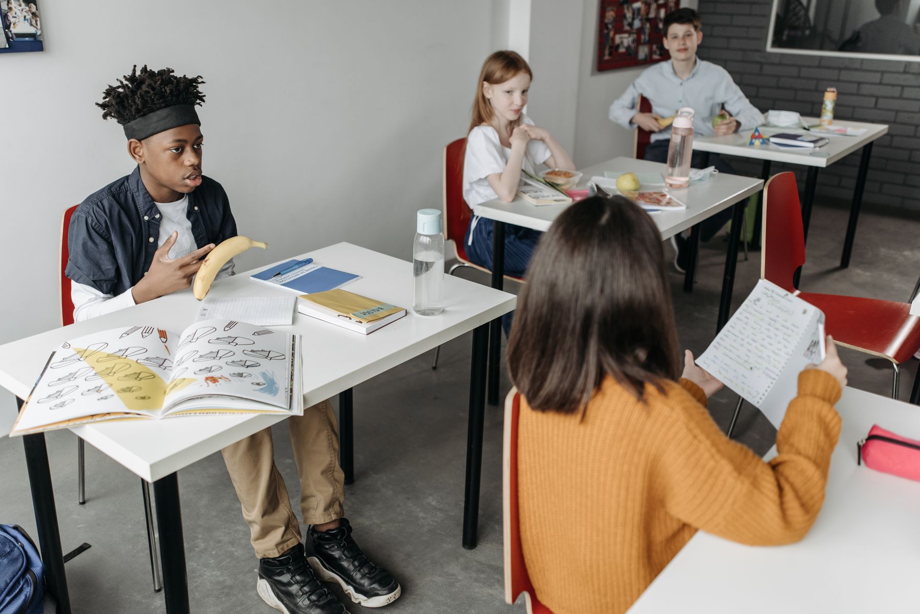 A diverse group of children learning together around a classroom table