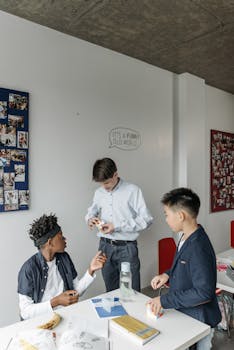 Three diverse students engaged in a collaborative activity inside a classroom setting.