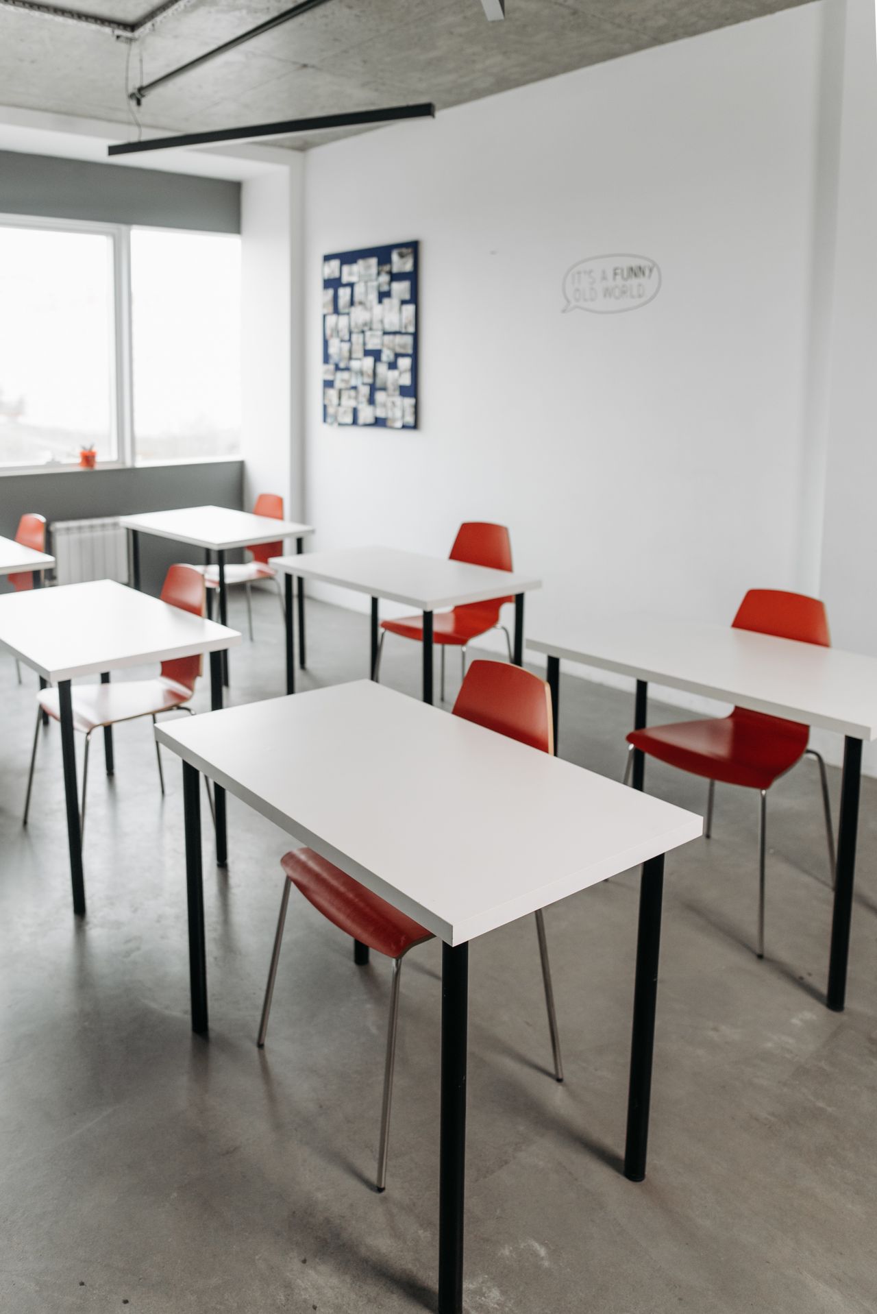classroom-decor-hero Bright modern classroom with white desks and red chairs