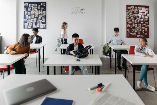 Students of various backgrounds engage in a modern classroom setting.