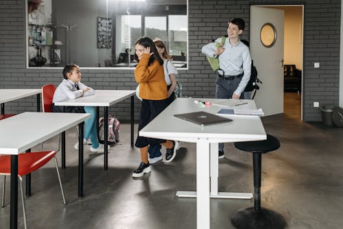 Young Students Walking In the Classroom