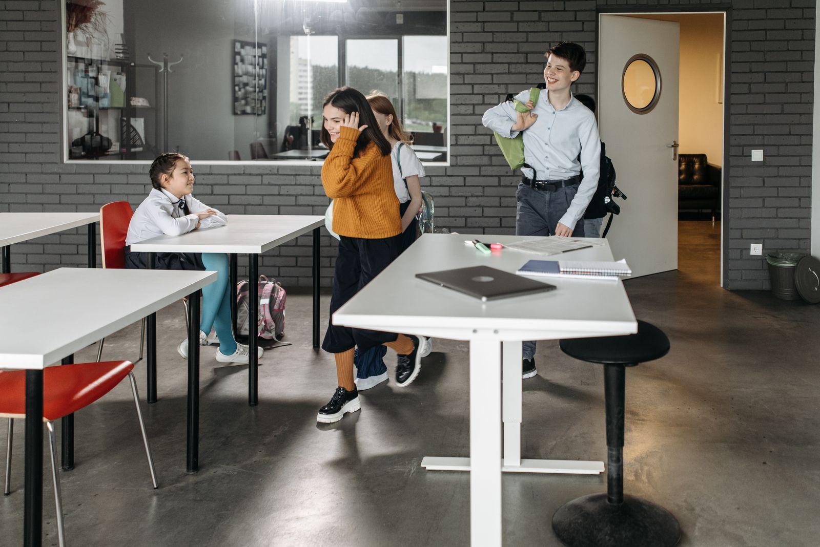 Young students walking through a classroom