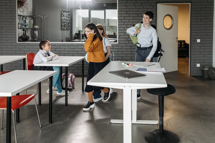 Young Students Walking In The Classroom