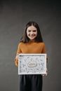 Woman in Brown Turtleneck Sweater Holding White Printer Paper
