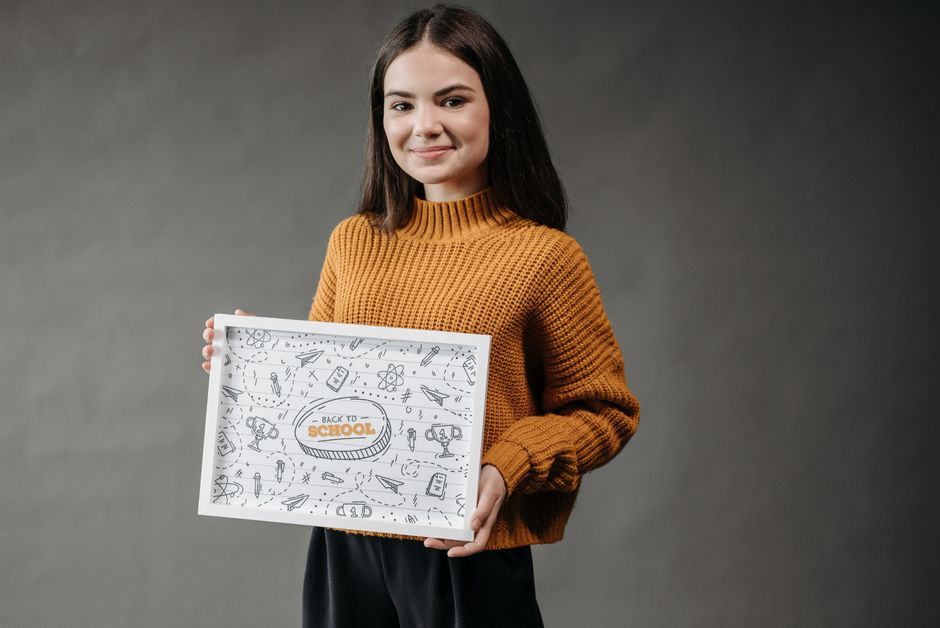 Photo by Pavel Danilyuk on Pexels A smiling teenage girl holds a back-to-school poster in a studio setting. - Photo by Pavel Danilyuk on Pexels