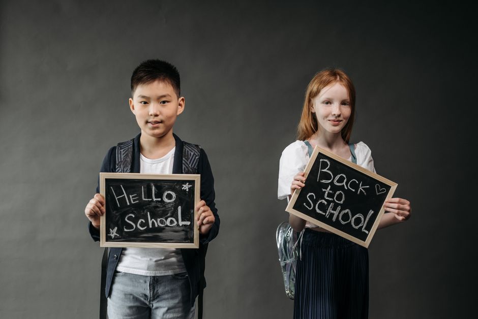 Kids with backpacks and school-themed supplies