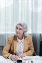 Woman in Brown Blazer Sitting by the Table