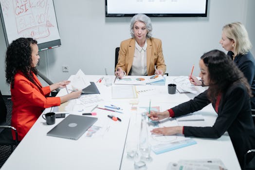 A diverse team of businesswomen engaged in a collaborative meeting at the office.