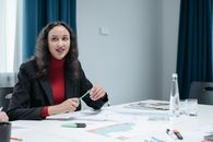 Woman in Black Blazer Holding Pen
