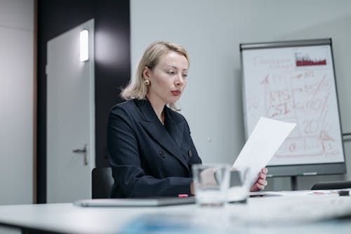 Woman Reading Papers in a Office