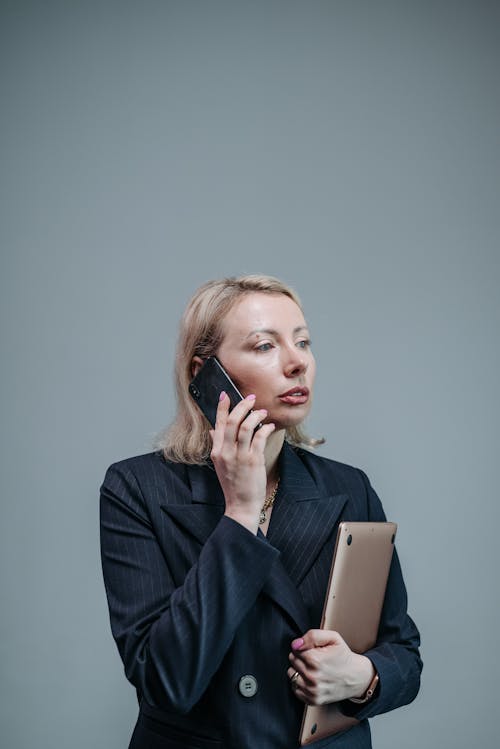 Free Business Woman in Black Blazer Having a Phone Call Stock Photo