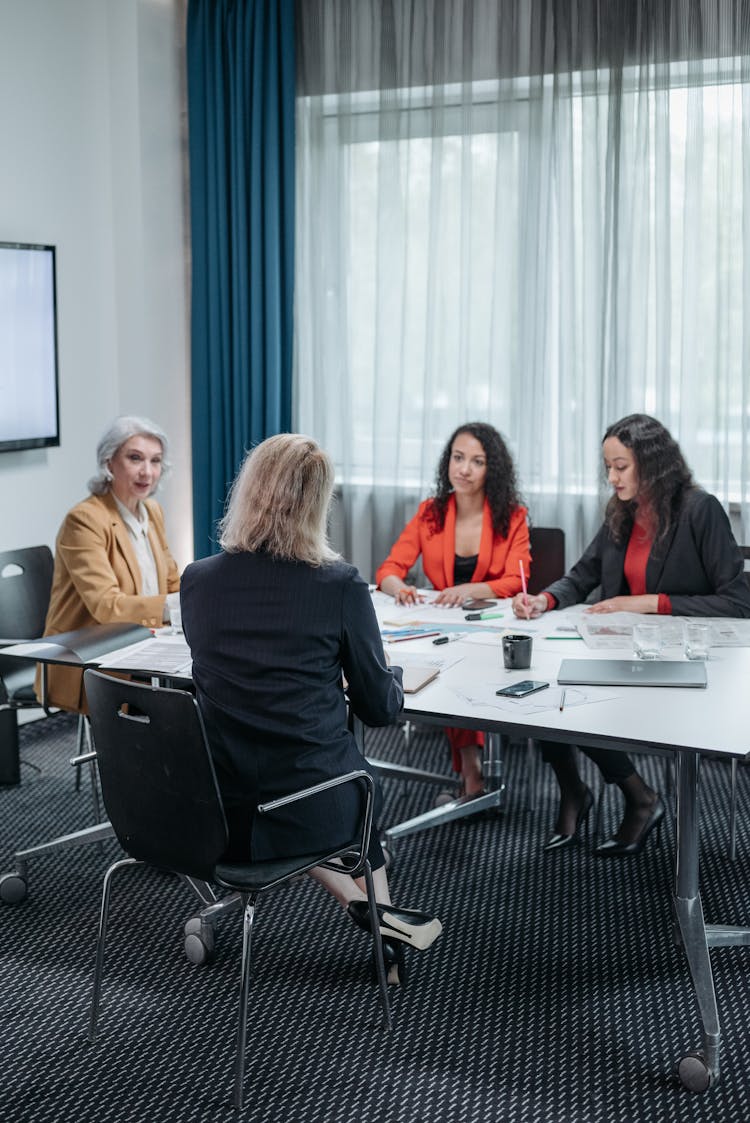 Business Women Having A Meeting Inside The Office