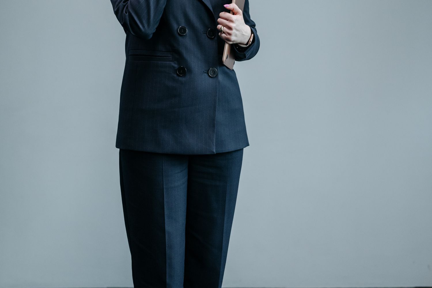 Woman in dark jeans with tweed jacket