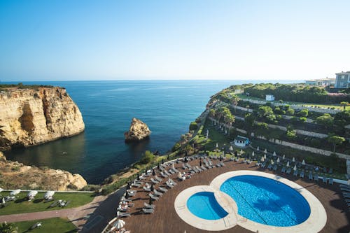 Sun Loungers Around the Pool on the Seaside Cliff in a Resort