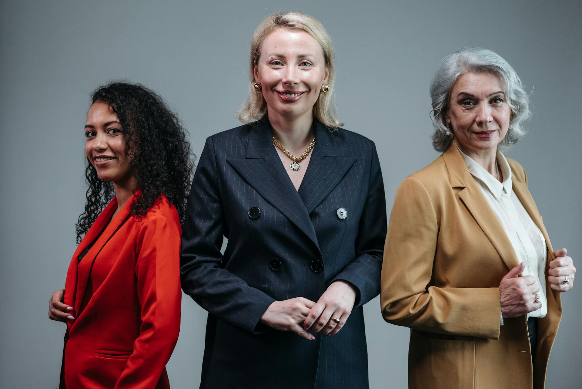 Women in Business Attire Smiling at the Camera