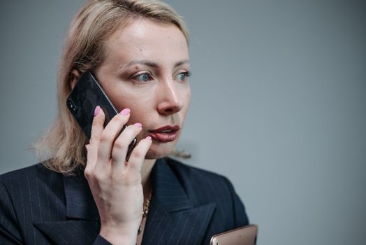 Woman in Black Blazer Holding Black Smartphone