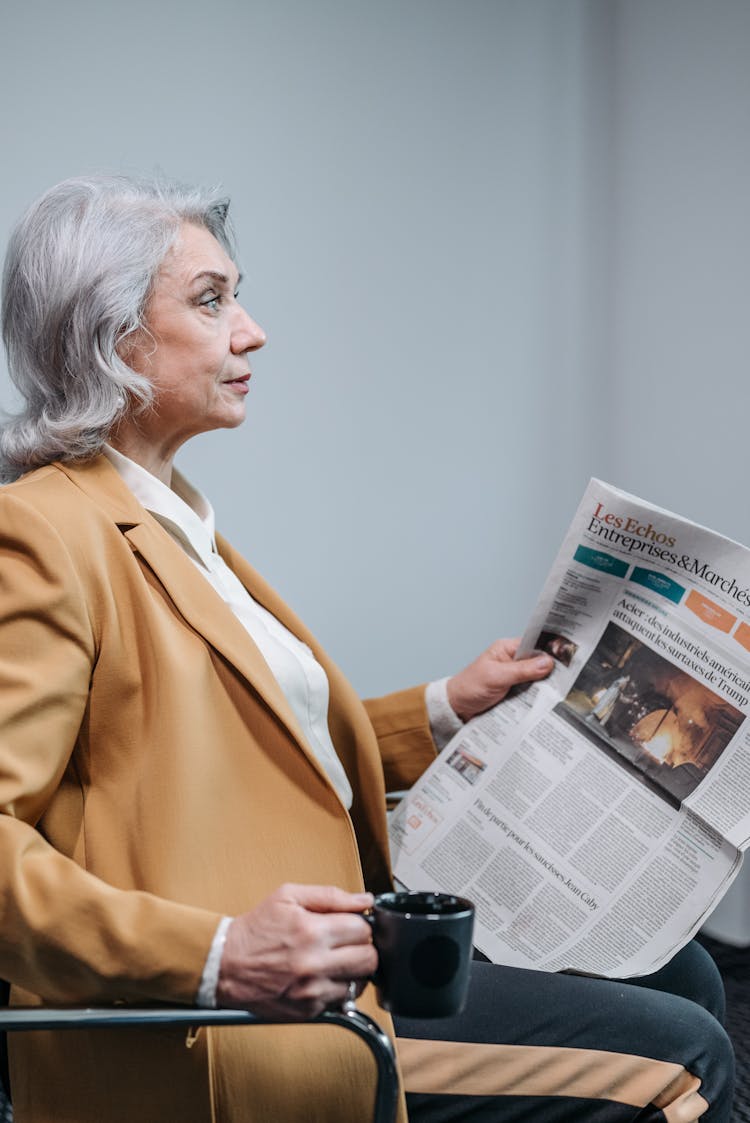 A Businesswoman Holding A Newspaper 