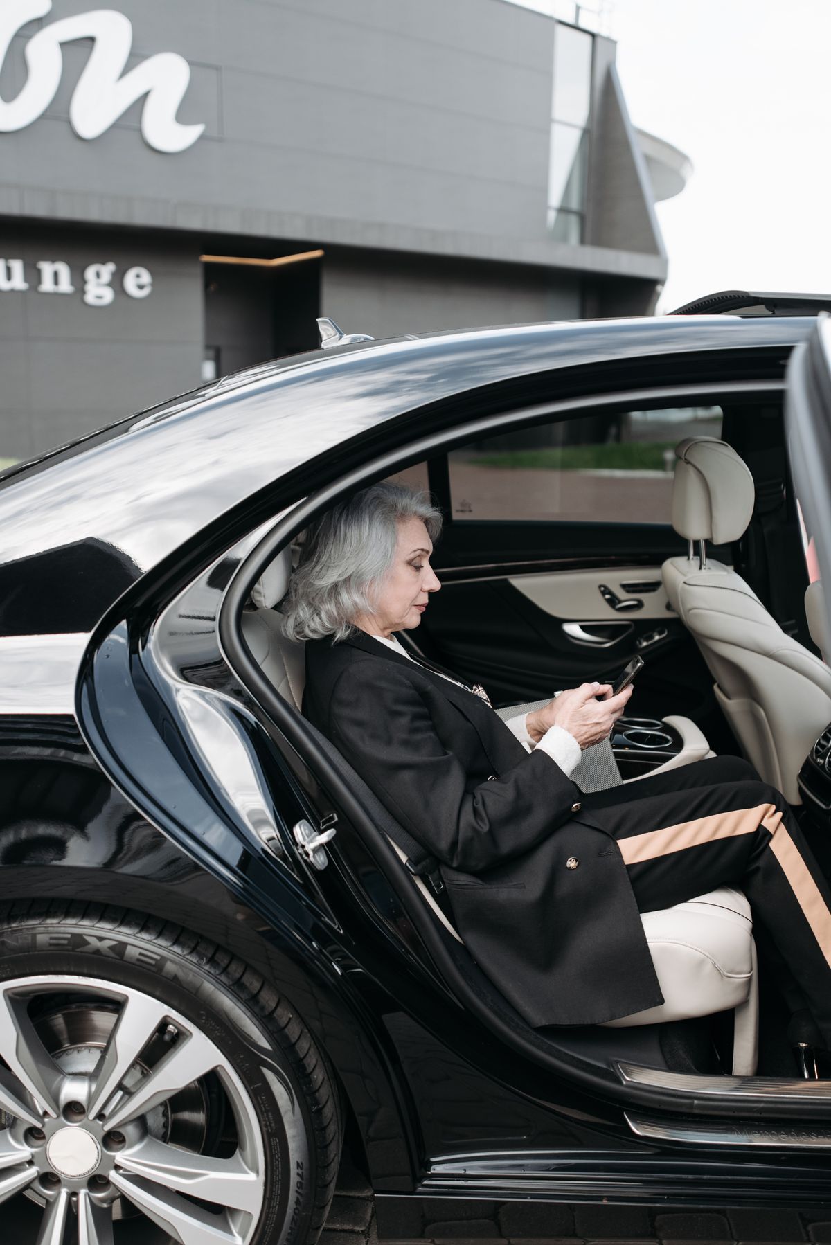 Executive passenger seated in a black luxury vehicle for private chauffeur travel
