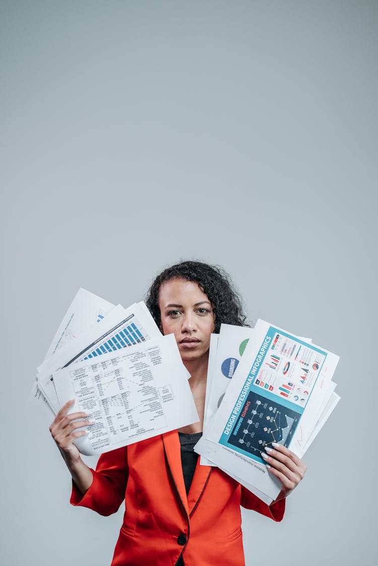 Woman Holding White Paper With Graphs And Charts