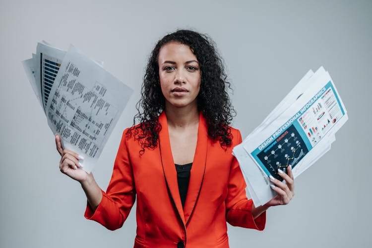 A Woman Holding White Paper With Graphs And Charts