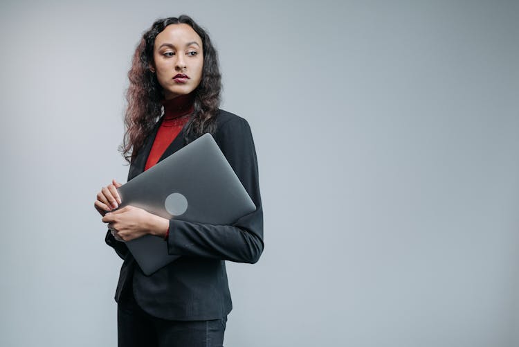 Woman In Business Attire Carrying A Laptop