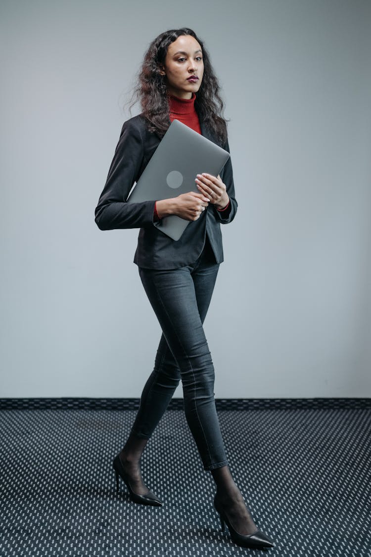 A Woman With A Laptop Walking