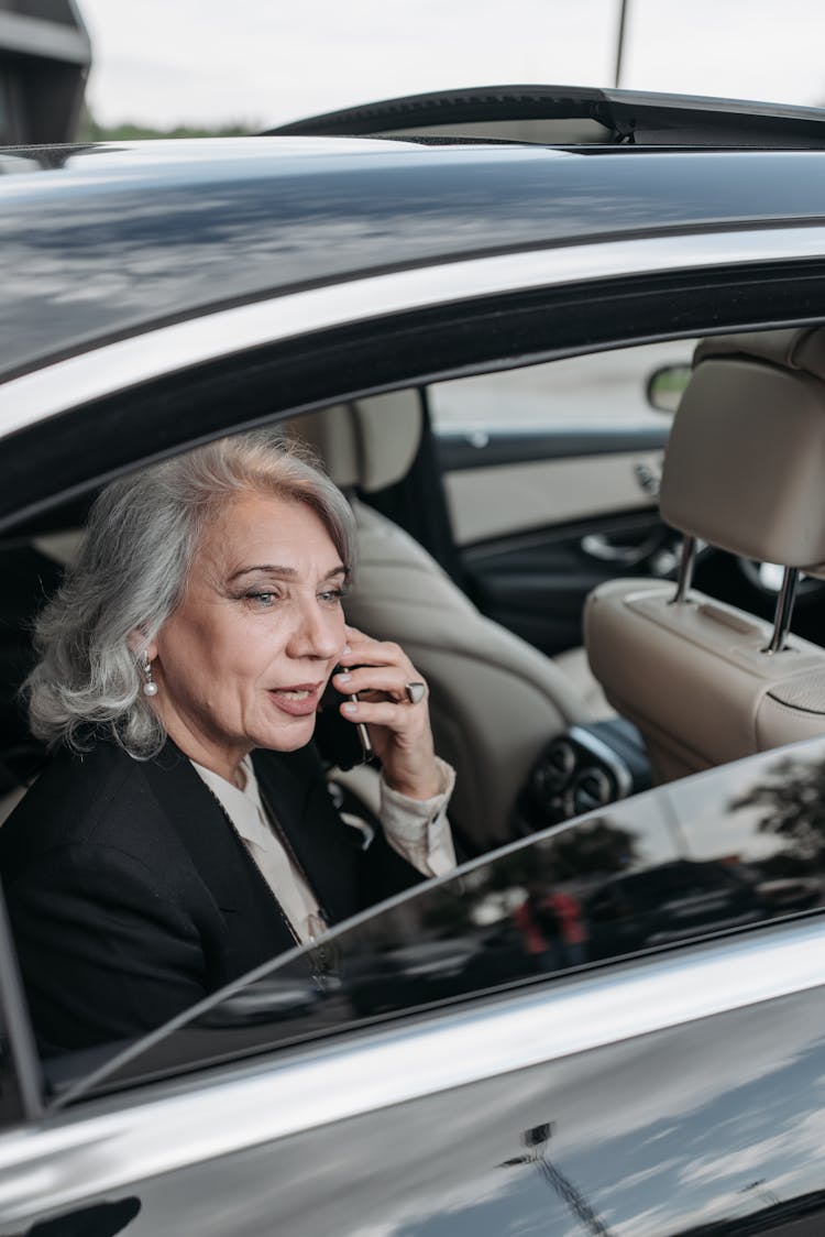 Woman In Black Blazer Sitting Inside The Car