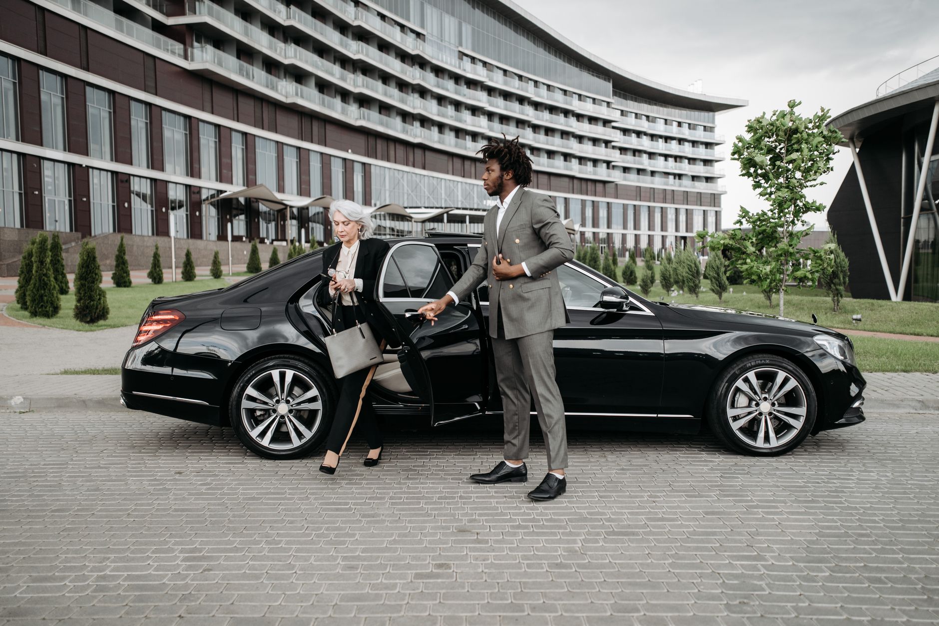 https://www.pexels.com/photo/woman-in-black-blazer-standing-beside-black-car-8425035/