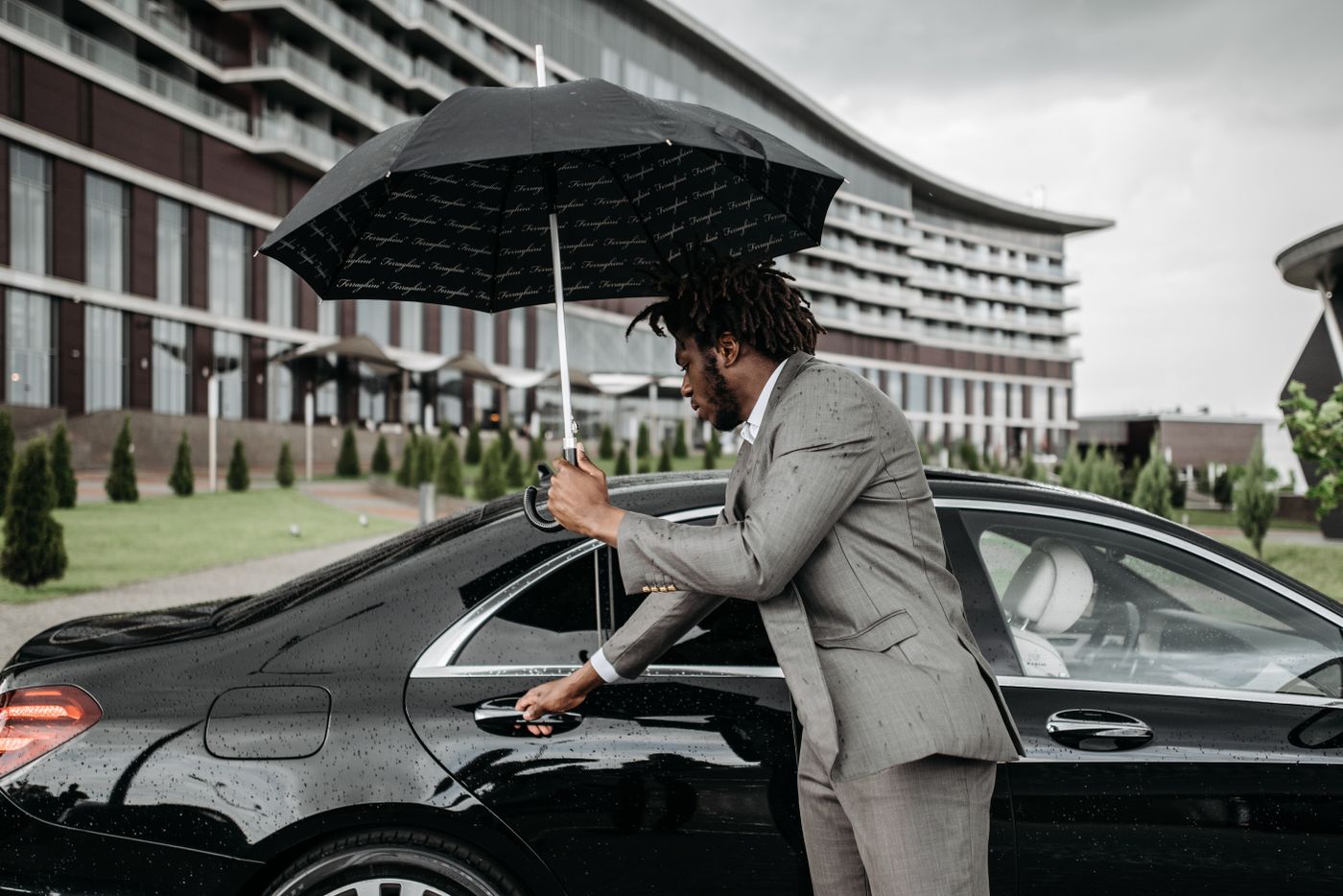 Chauffeur opening the car door for a client