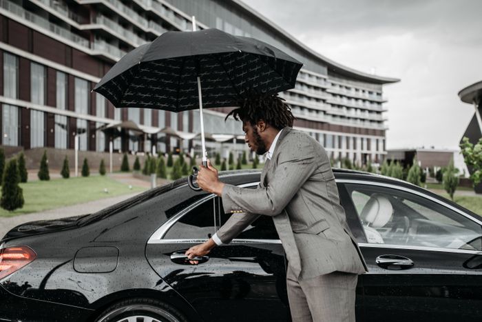 Valet opening a car door for a customer