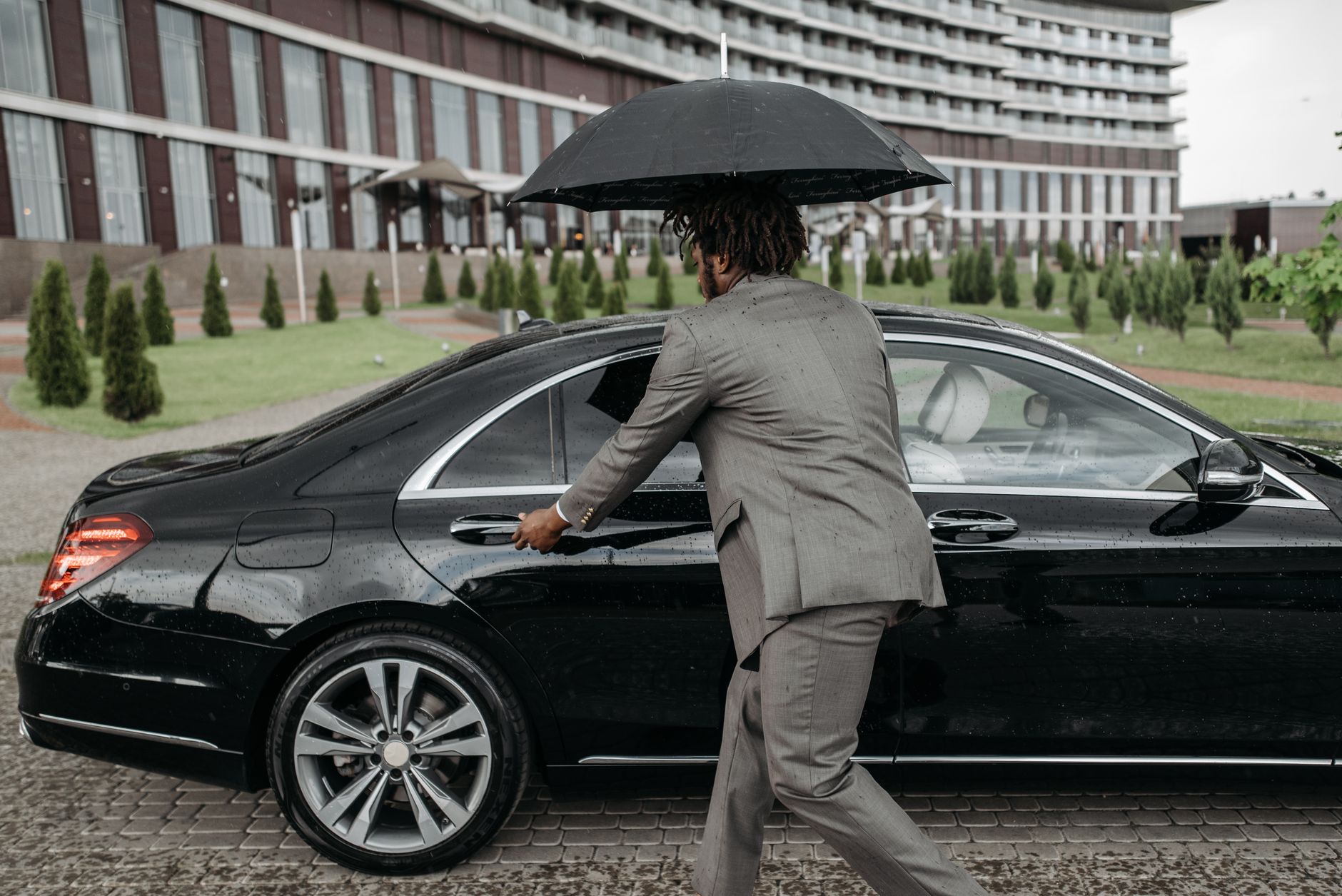 Guarded hotel car park with SUVs parked at night in Lekki
