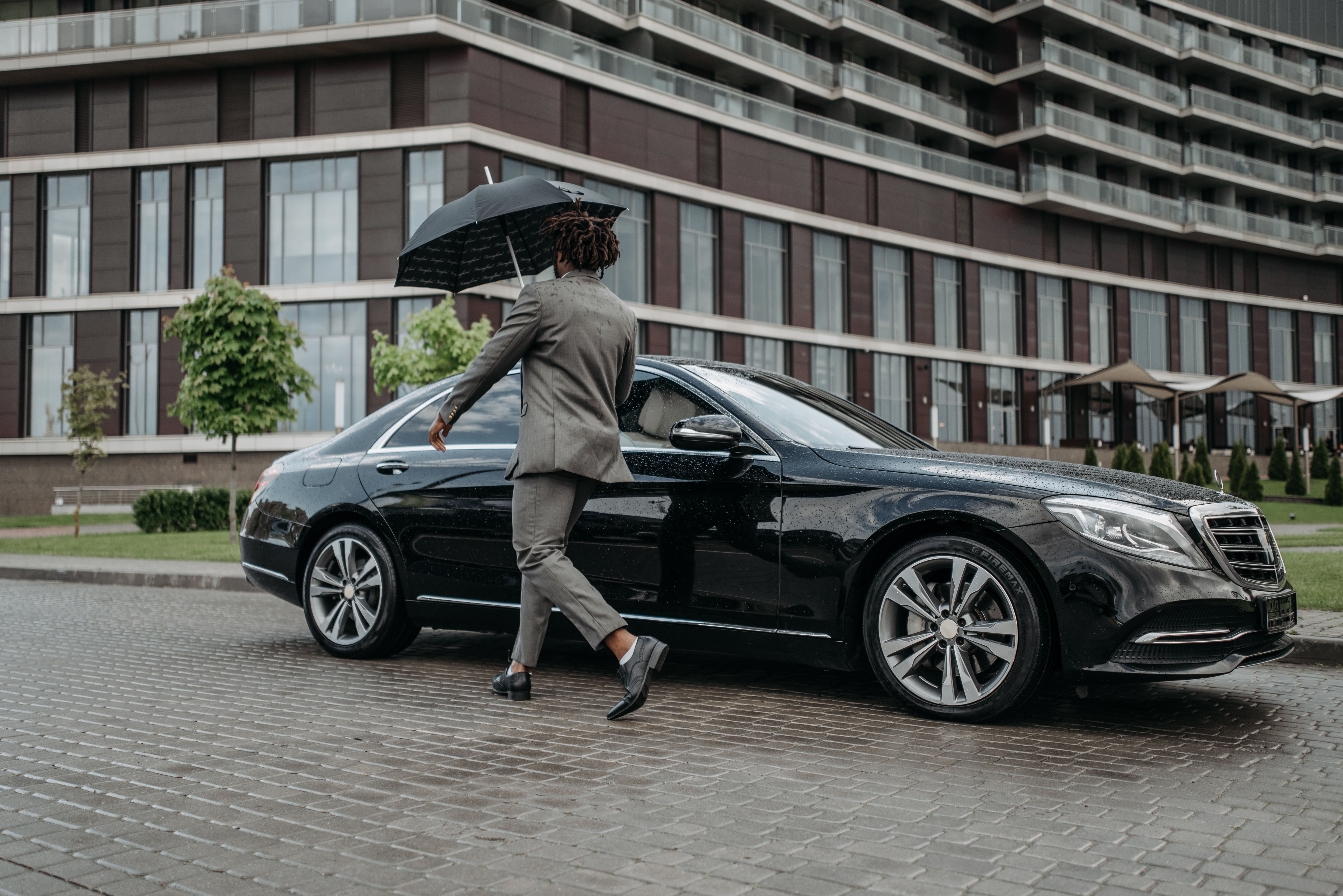A Man Opening the Door of a Black Car best airport transfers