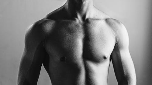 Black and White Photography of a Topless Man