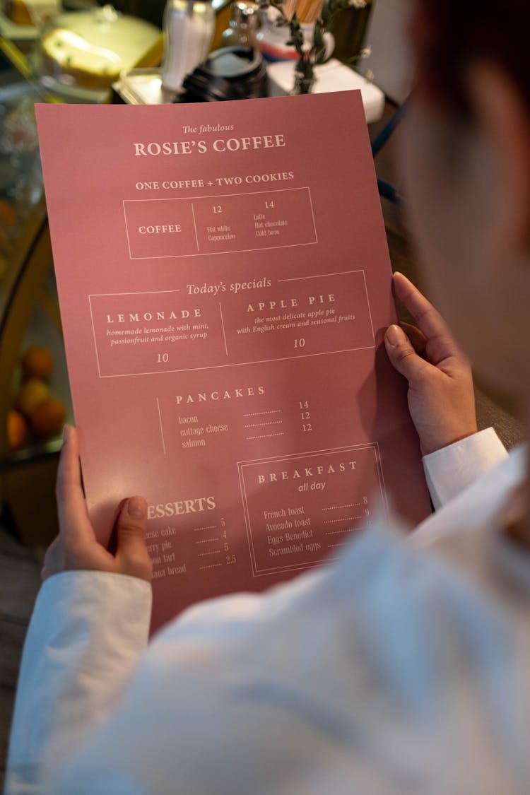 A Person Holding A Food Menu