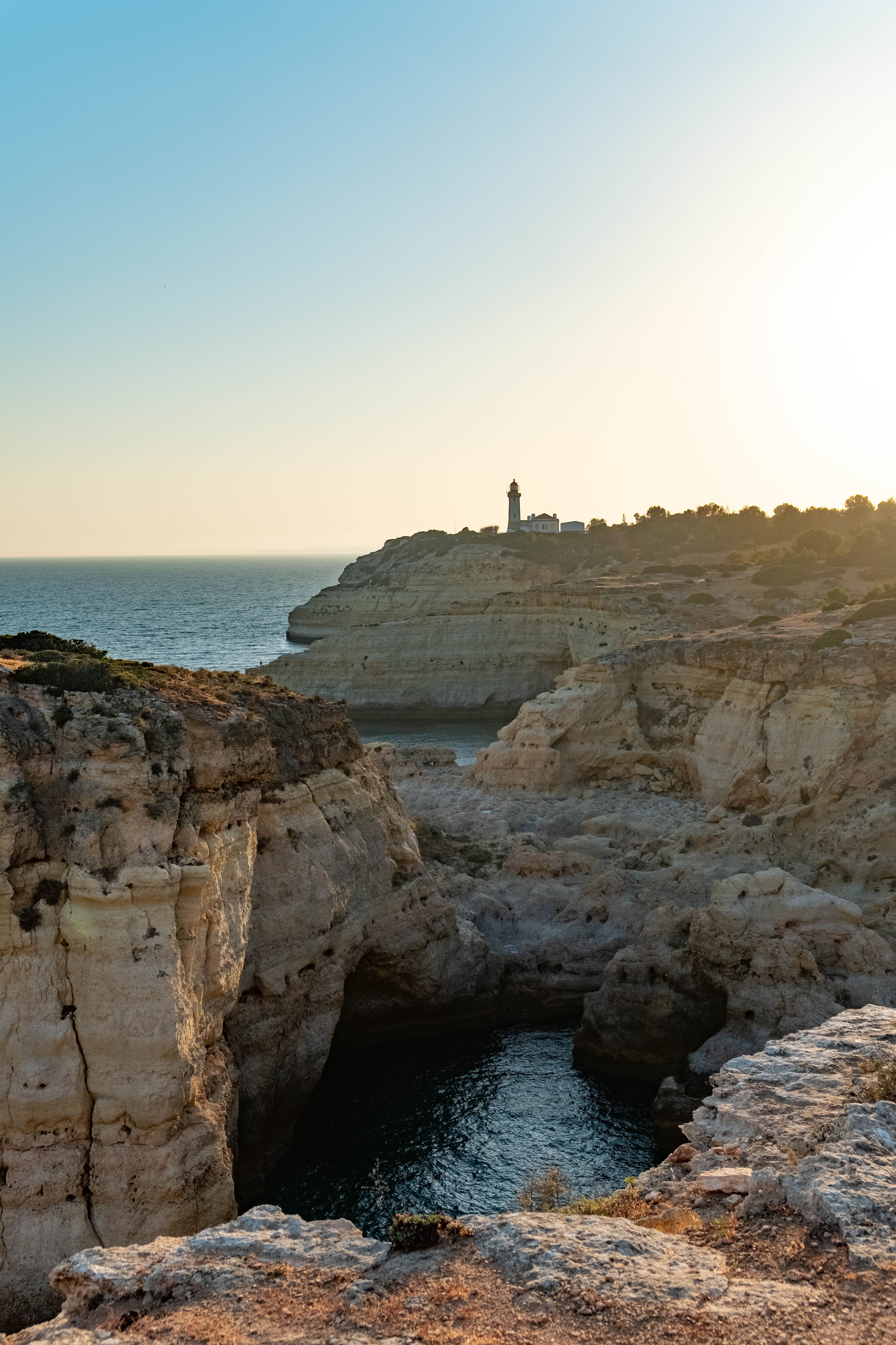 Red and White Lighthouse on Cliff · Free Stock Photo