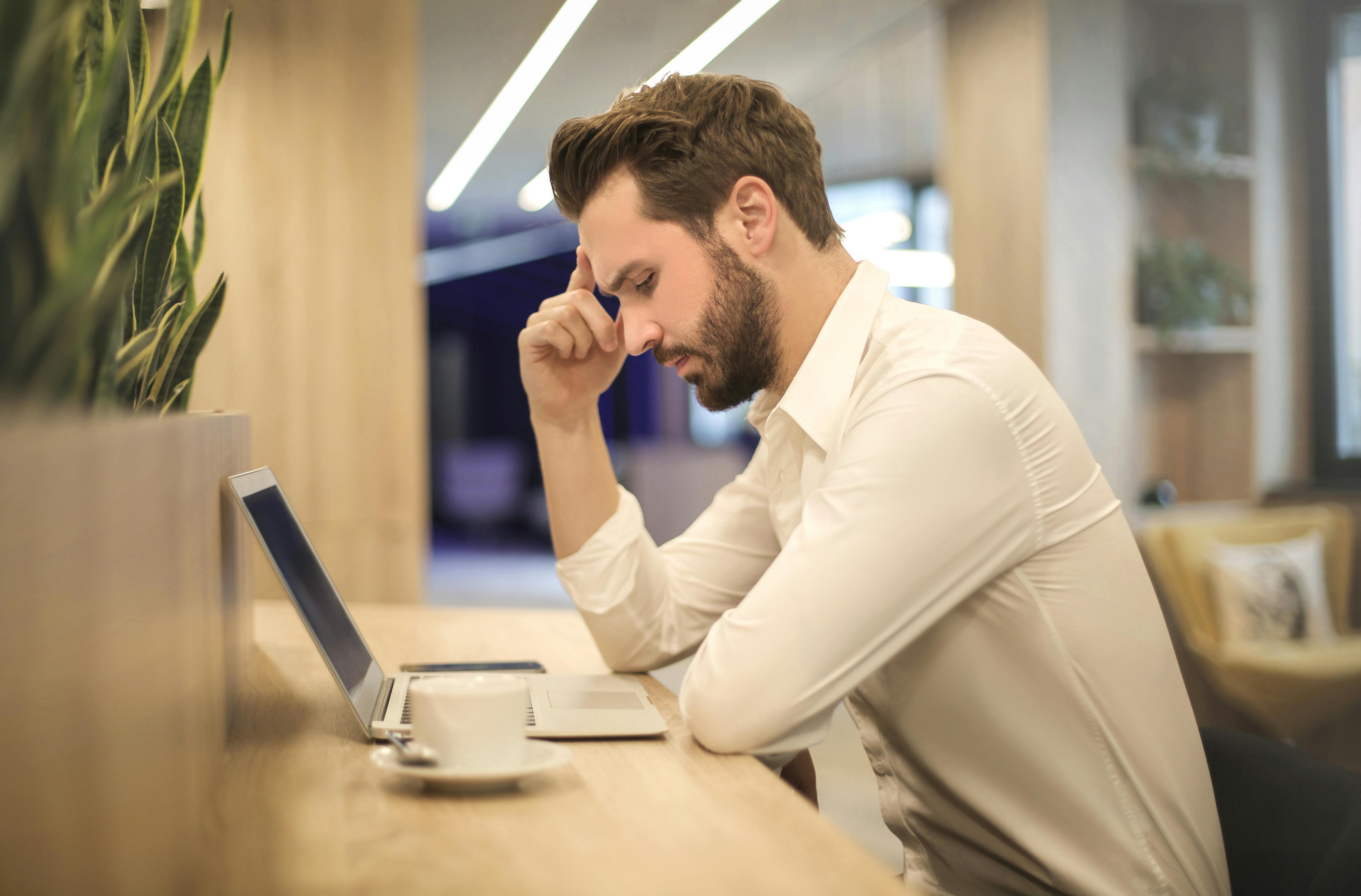 Man looking at his laptop | Photo: Pexels