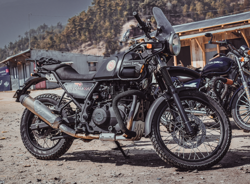 Free A Royal Enfield Himalayan motorbike parked outdoors in a rural Indian setting. Stock Photo