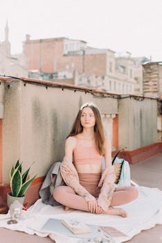 Woman practicing yoga meditation on a sunny rooftop, embracing relaxation and mindfulness.