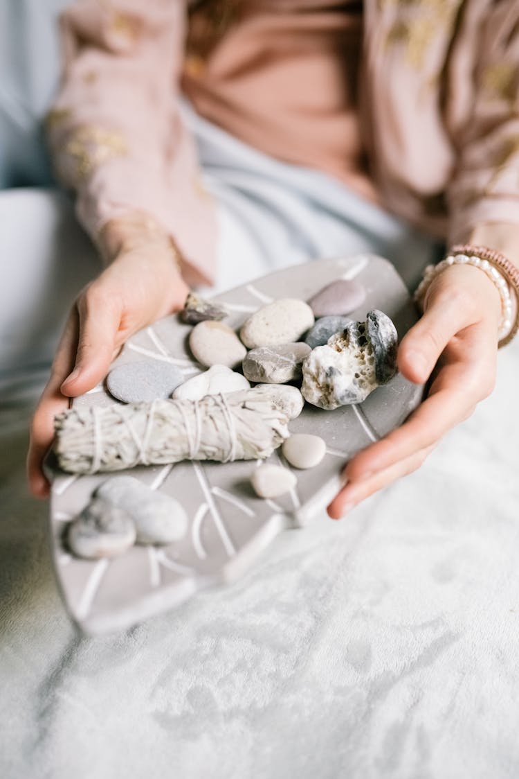 A Person Holding White And Gray Stones