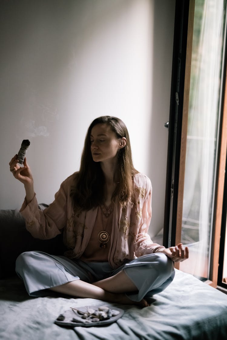 Woman Holding A Burning Sage