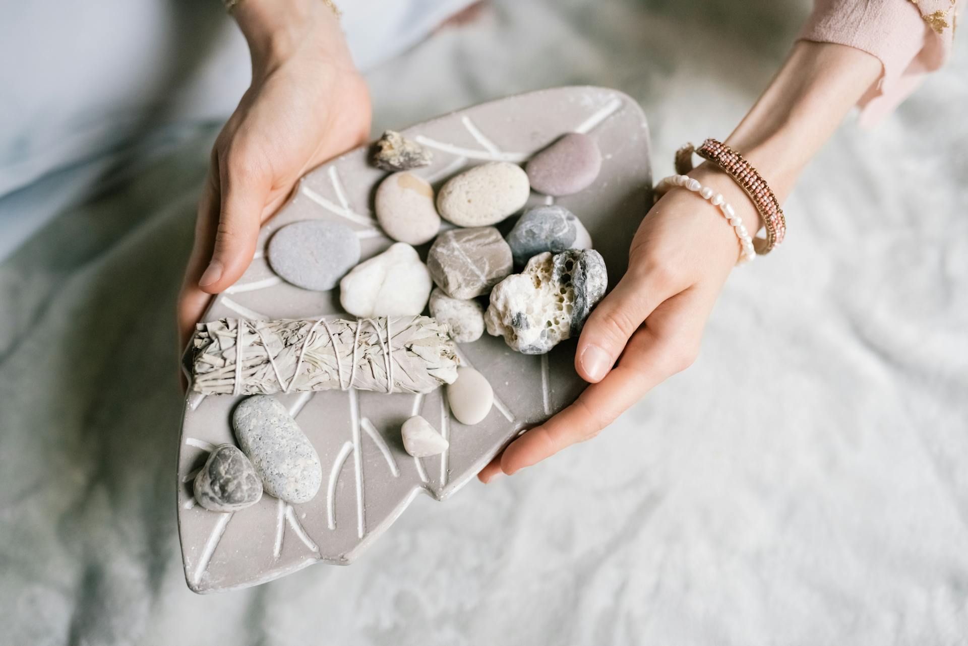 A Person Holding White and Gray Stones