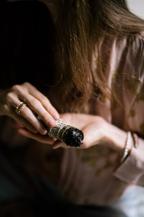 
Person Holding a Burning Sage