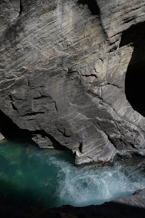 Brown Rock Formation on Body of Water