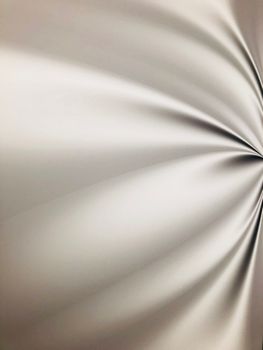 A close-up of beige satin fabric with smooth, radial folds creating a shining abstract pattern.