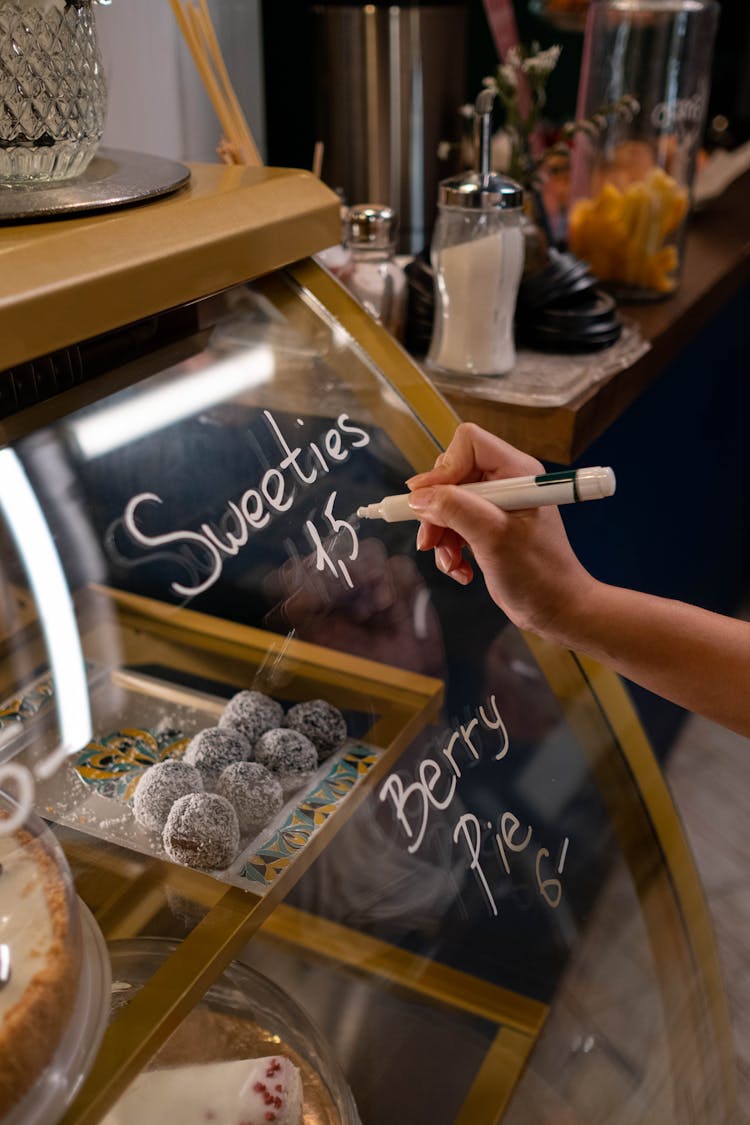 Person Writing On Clear Glass 