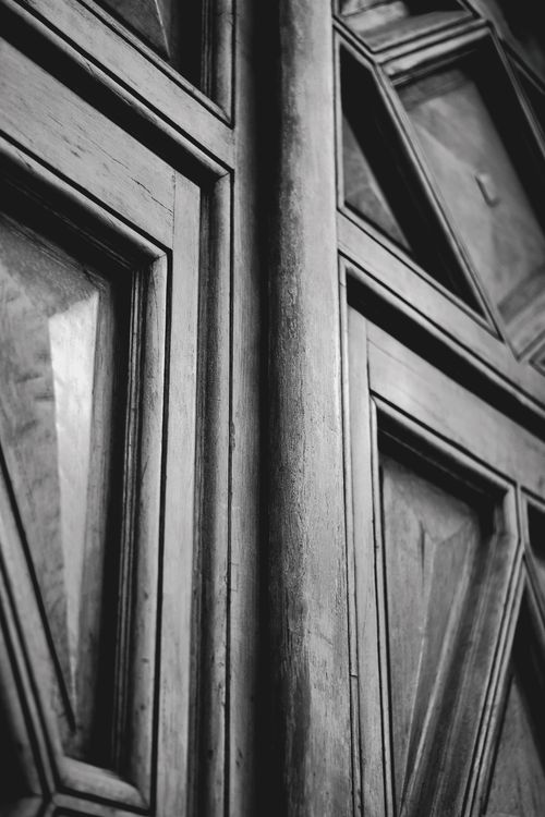 Free Artistic black and white close-up of a vintage wooden door featuring geometric patterns. Stock Photo